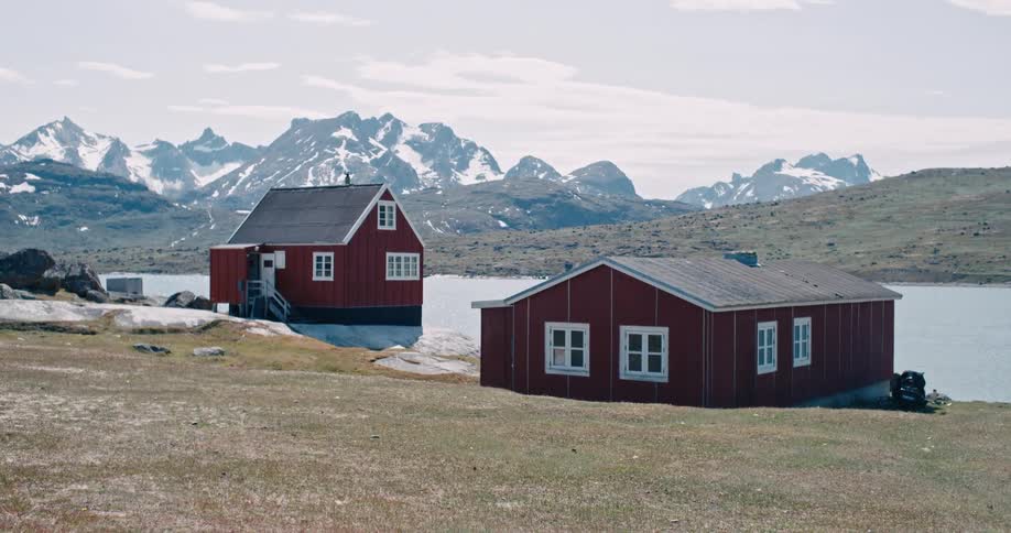 Two lone houses near a mountain lake
