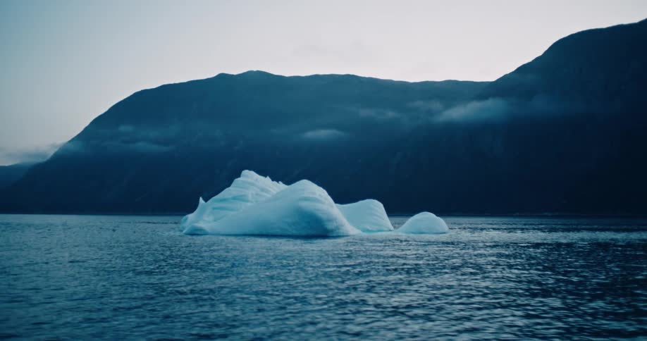 Melting icebergs float off the arctic coast