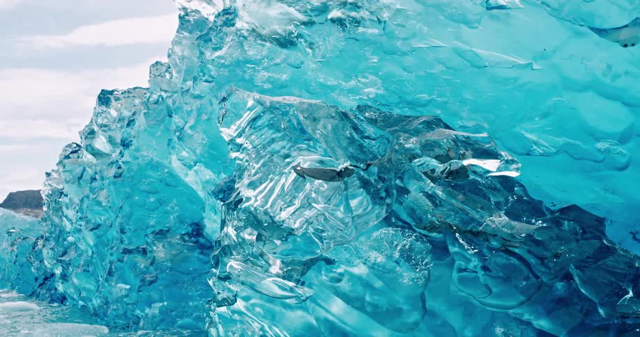 A blue translucent iceberg in the arctic