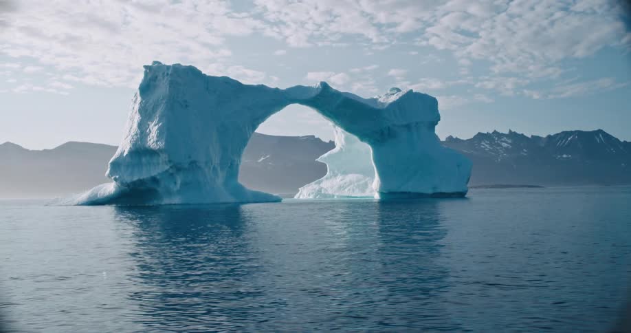 Floating iceberg with a natural arch shape