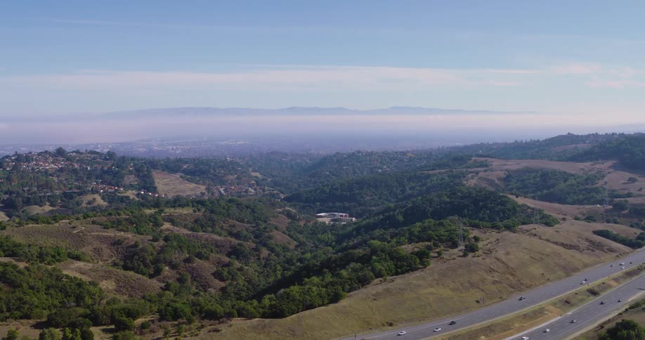 Aerial of forest area with busy highway nearby