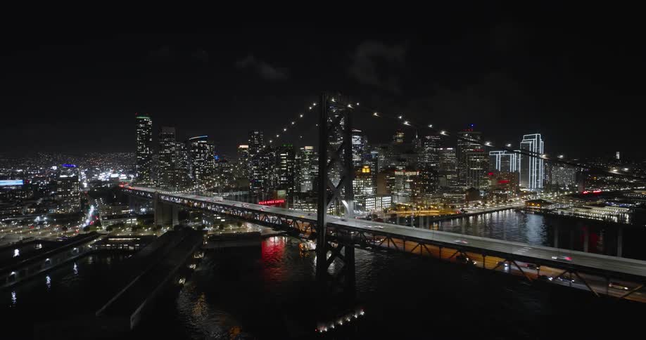 Vehicles travel over the bridge at night