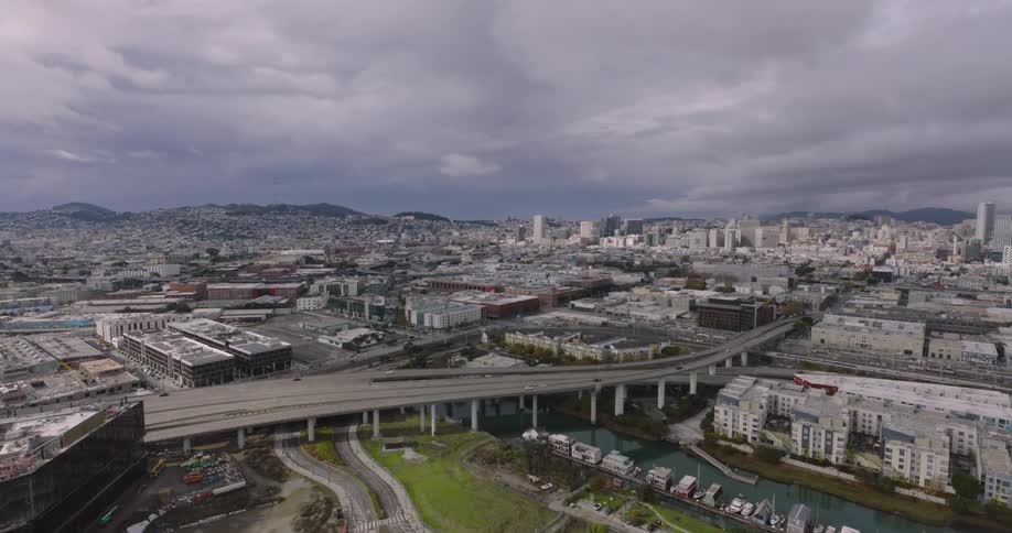 Skyline of bridges moving cars and buildings in a metropolitan area during the day