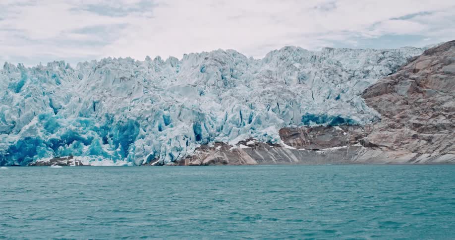 A large glacier slipping into the ocean