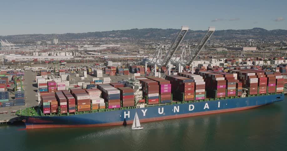 Aerial of a large cargo ship being docked at a port