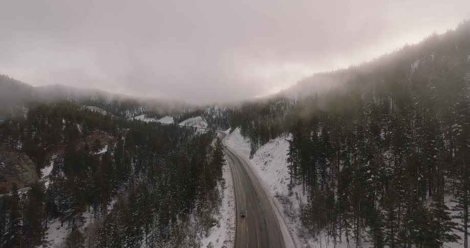 Road on a mountain under the clouds at winter