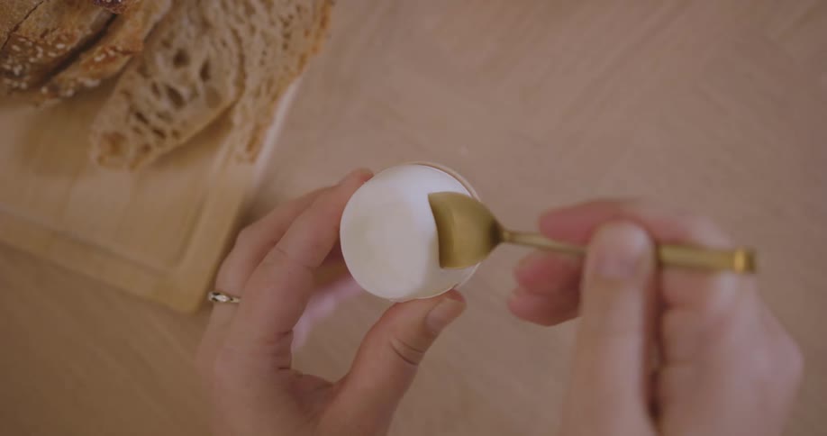 Eating a hard boiled egg with a spoon