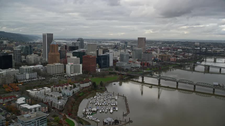 Aerial view of bridges over a river on a waterfront city at evening