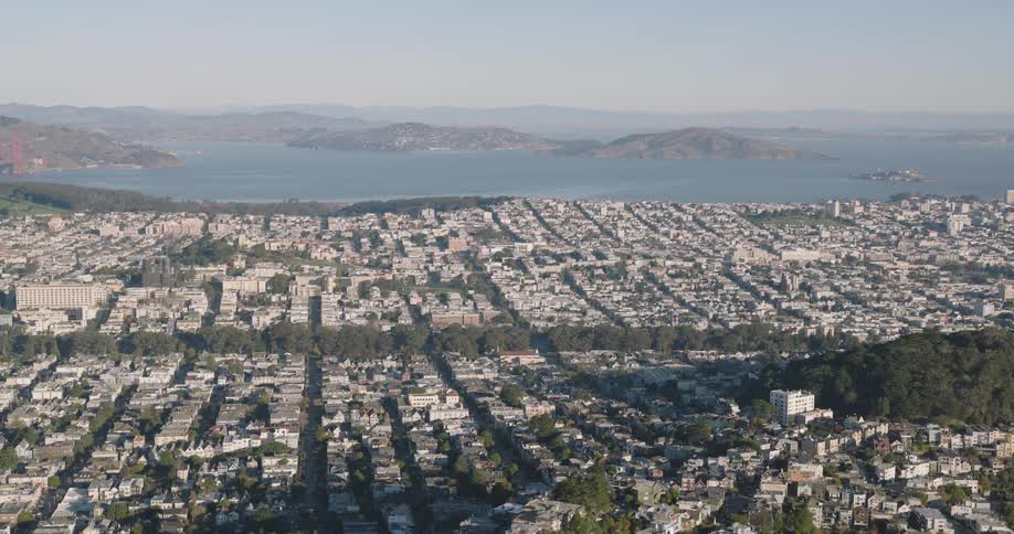 Aerial of fog covered residential area and nearby water