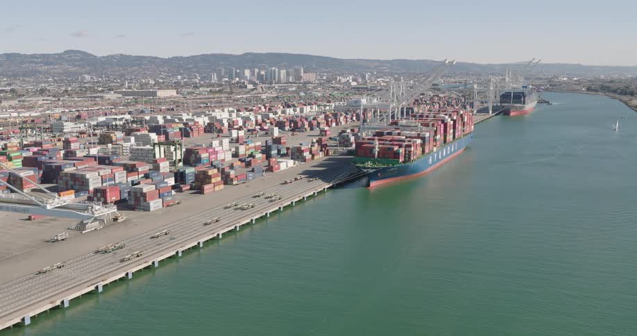 Aerial of a cargo ship anchored in the citys urban port during the day