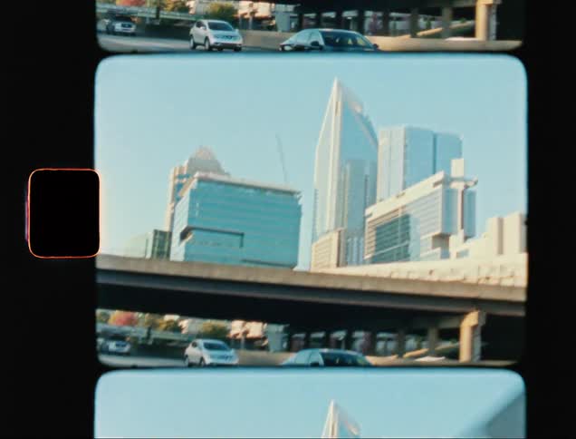 City skyline seen from a moving car caught on vintage film