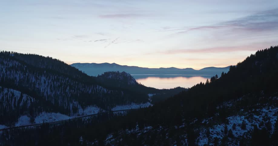 Aerial view of a lake in the mountains at sunset