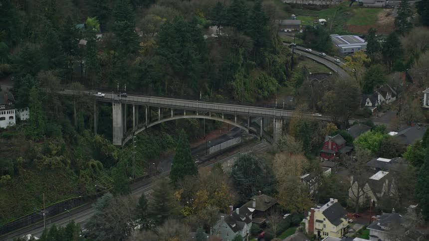Aerial view of cars driving over a bridge in a small town