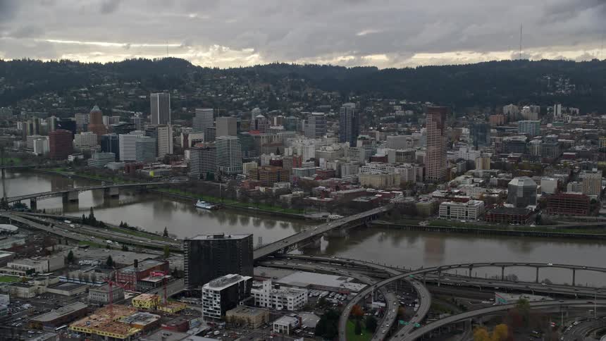 Aerial view of bridges over a river on a waterfront city at evening