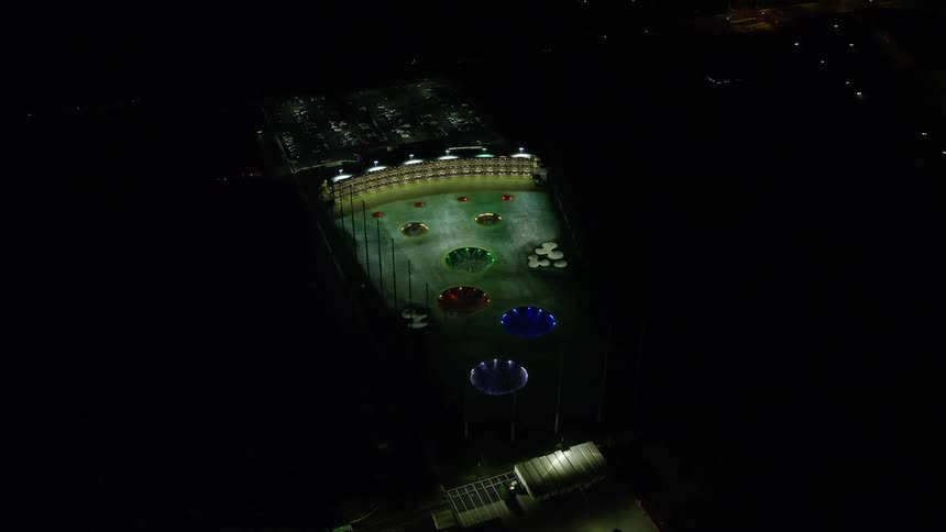 Skyline of an illuminated stadium in the urban city at night