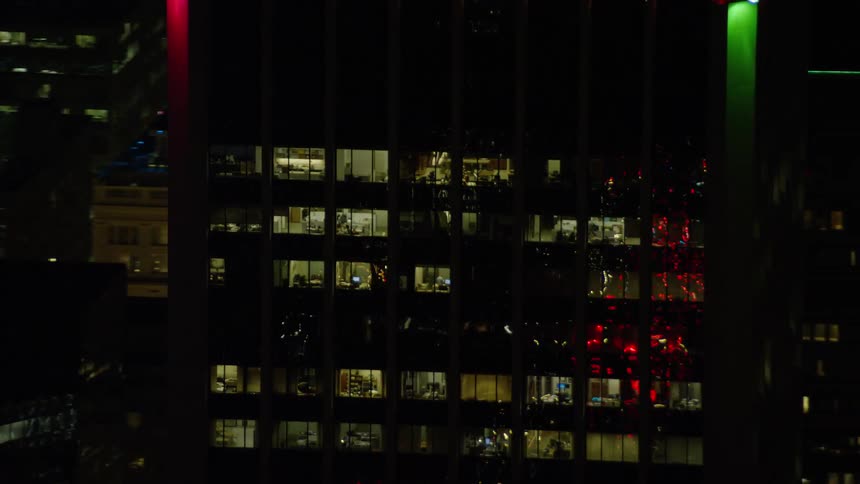 High rise apartment view of the top floors at night in a downtown city