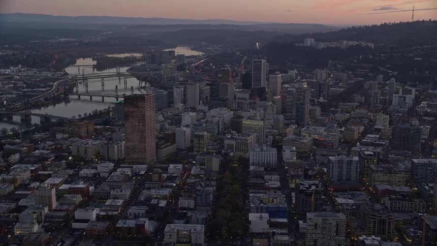 Buildings and skyscrapers in a metropolitan area at sunset