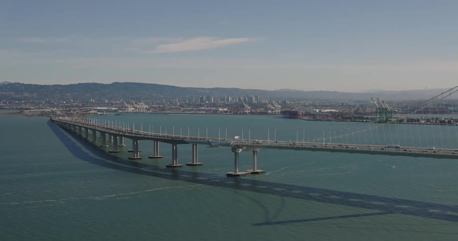 Bridge under the sea with a metropolis on the horizon