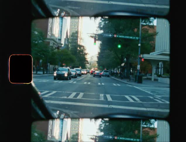 View from inside a car driving through the streets of a metropolis