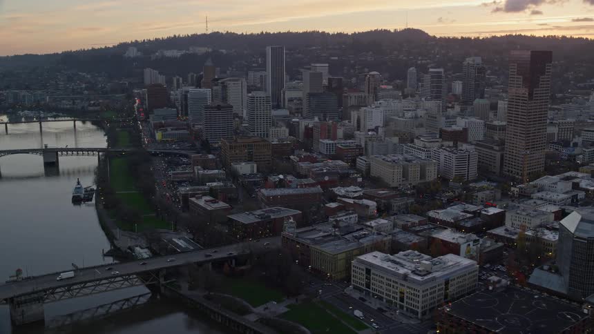 Aerial view of bridges over a river on a waterfront city at evening