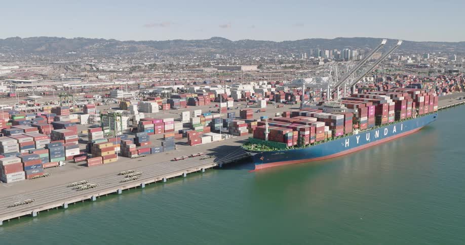 Aerial of a large container ship is docked at a port