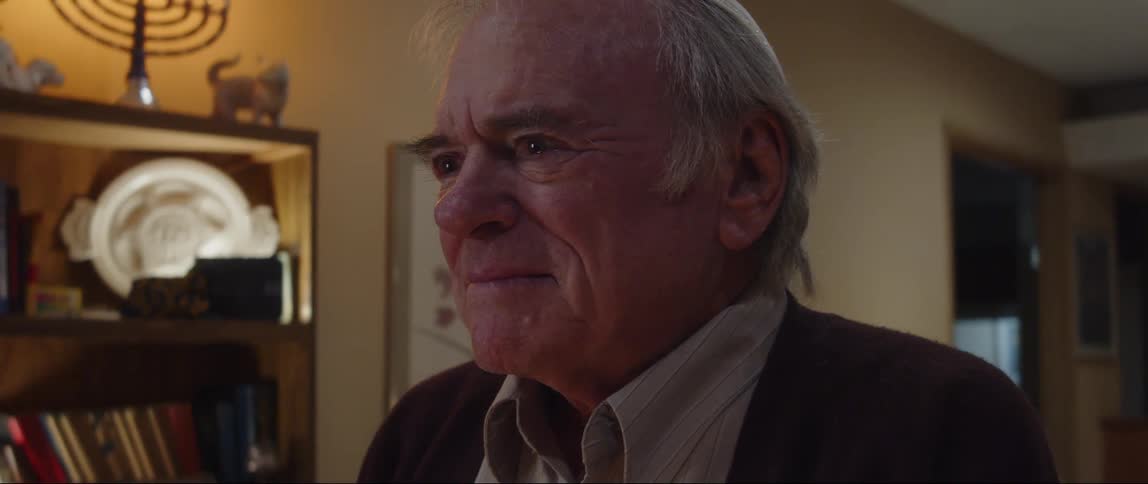 A man is staying a prayer near the hanukkah candles