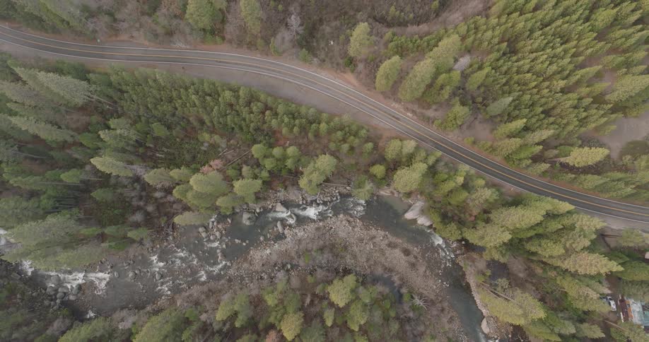 An aerial view of the river and highway and the woods