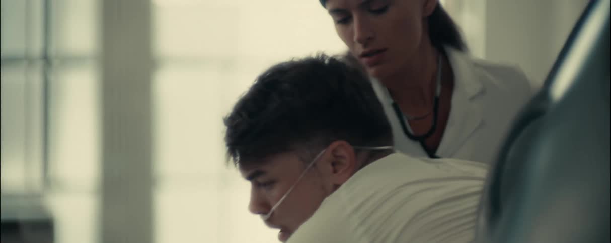Doctor helps a patient to get out of a futuristic pod
