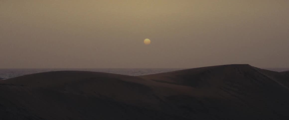 Landscape of barren mountains under the full moon