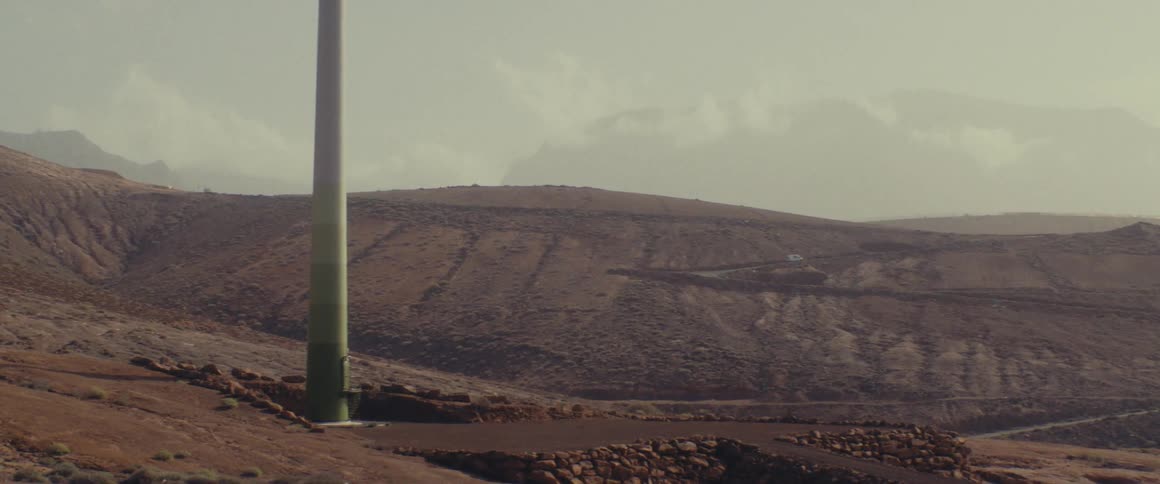 A vehicle climbing a mountain in the desert