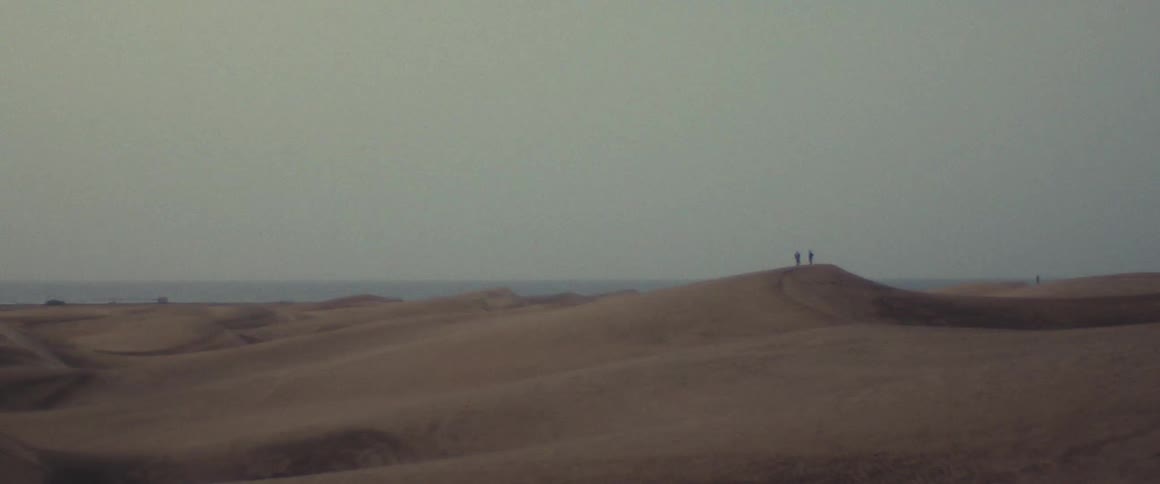 People adventuring in the sahara desert during the hot day