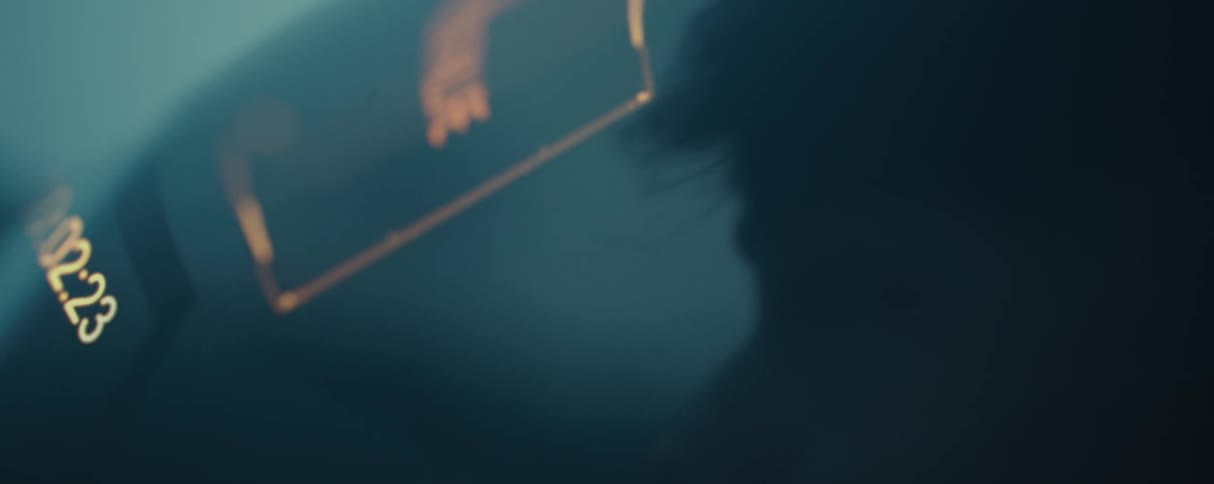 A person is looking at a count down in the dark