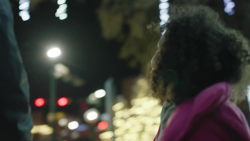 Girl looking at christmas decorations in the city streets