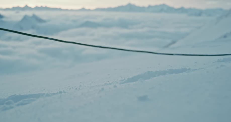 Closeup of a snowcovered ground with a person trekking