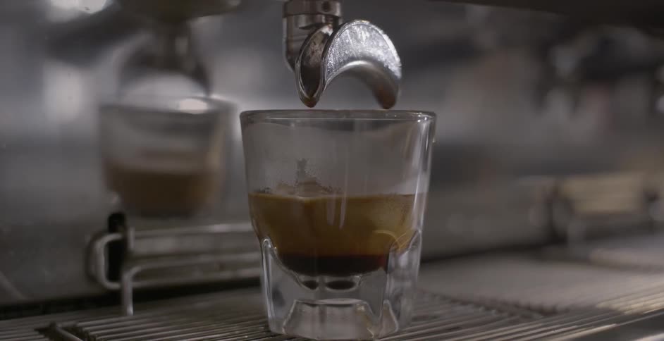 Espresso flows from a machine into a glass