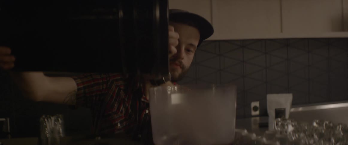 A man is pouring coffee beans into a container