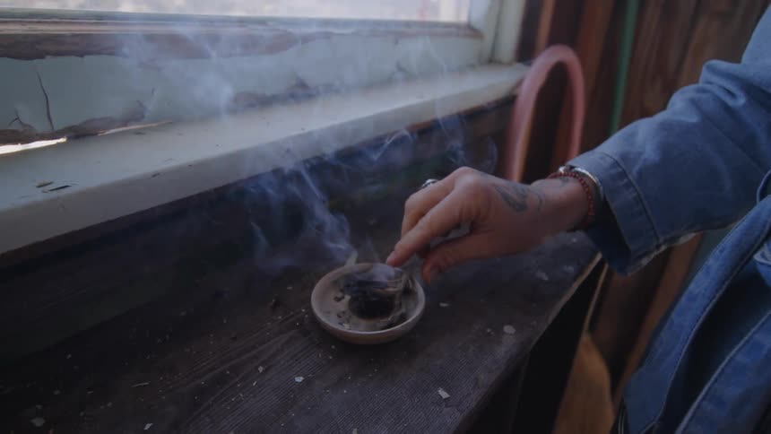 A woman lights incense
