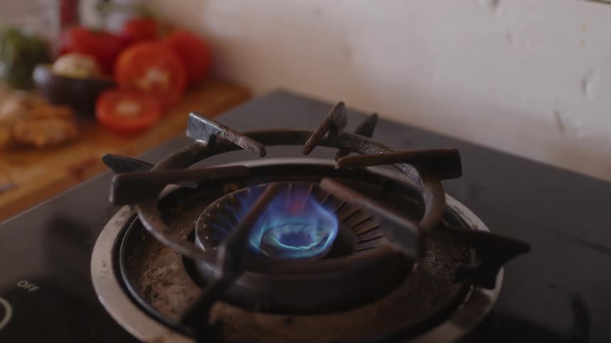 Turning on a gas stove at home