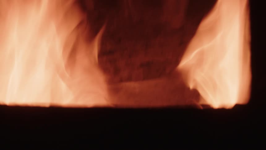 A fire is burning behind the window