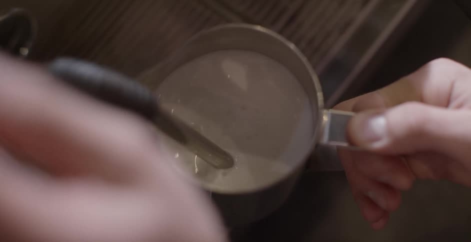 A person is filling a mug from a spout