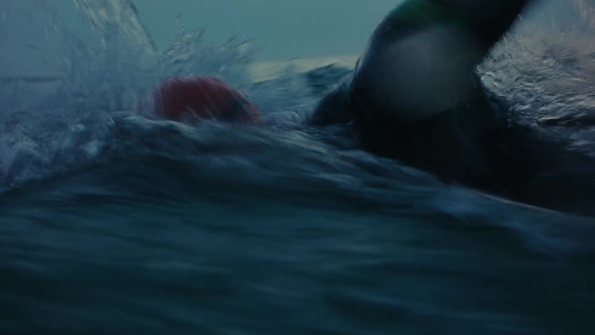 Person swimming inside the sea at sunset