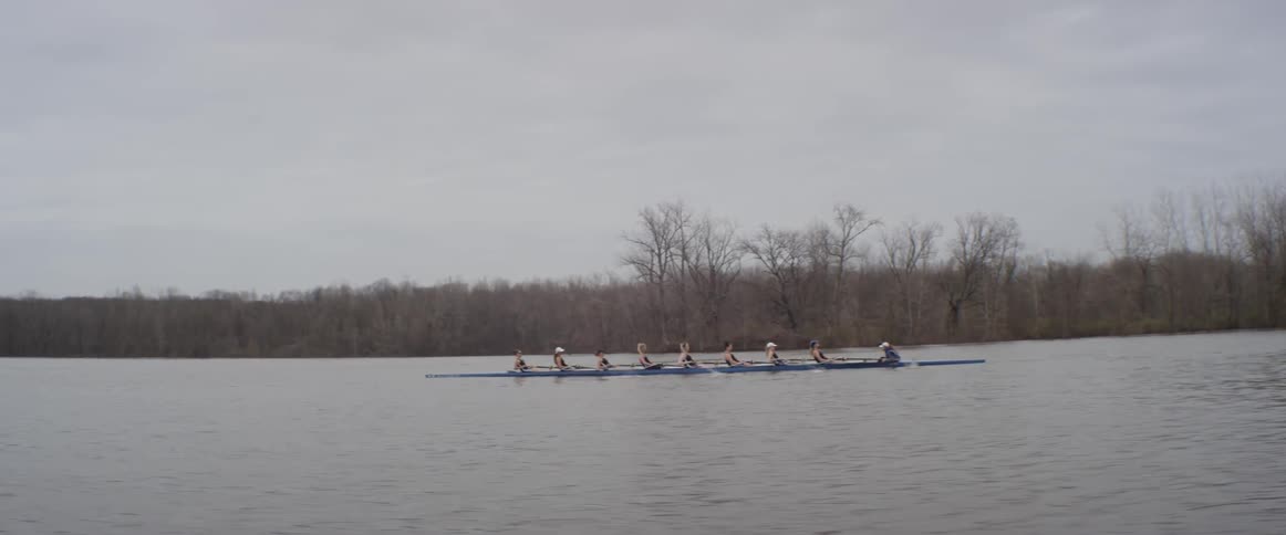 An eight person crew team rows a boat