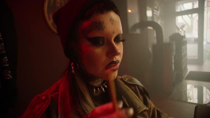 Thoughtful female tattoo artist spinning a pencil