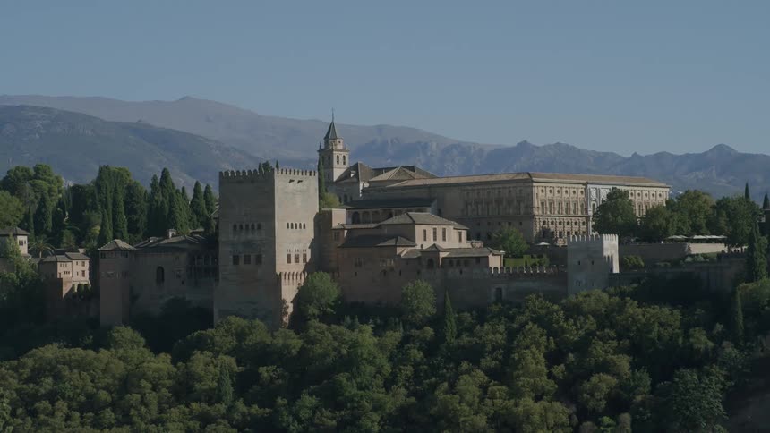 A building with ancient architecture similar to a castle in front of several trees