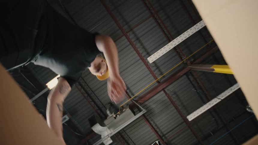 Man opening a box and placing a black shirt inside