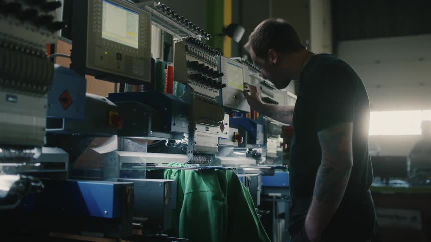 A man is operating a machine in the lab