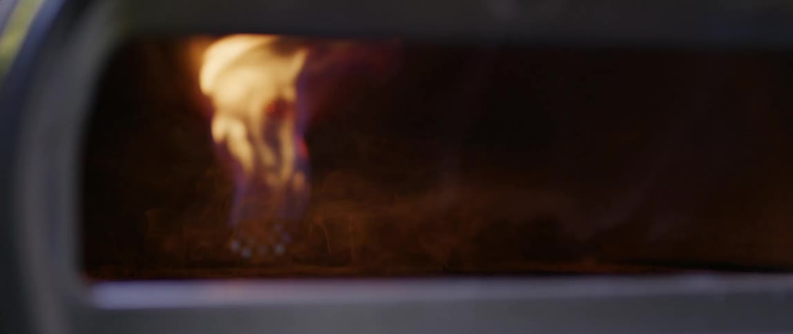 Window shows flames burning inside enclosed furnace