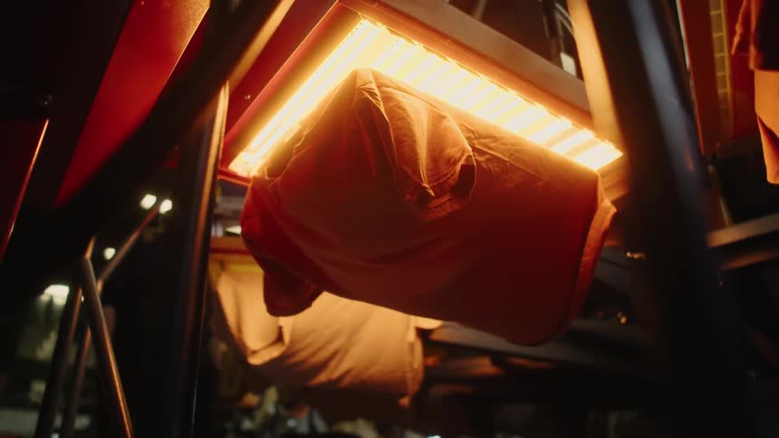 A machine dries shirts on a line