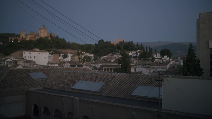 Historic landmarks surrounded by woods tower over town and nearby foggy valley
