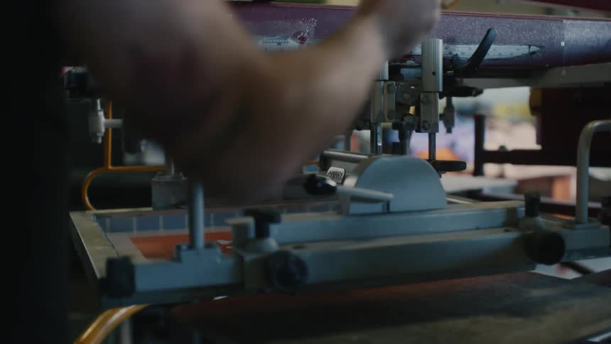 A man is using a machine in the workplace